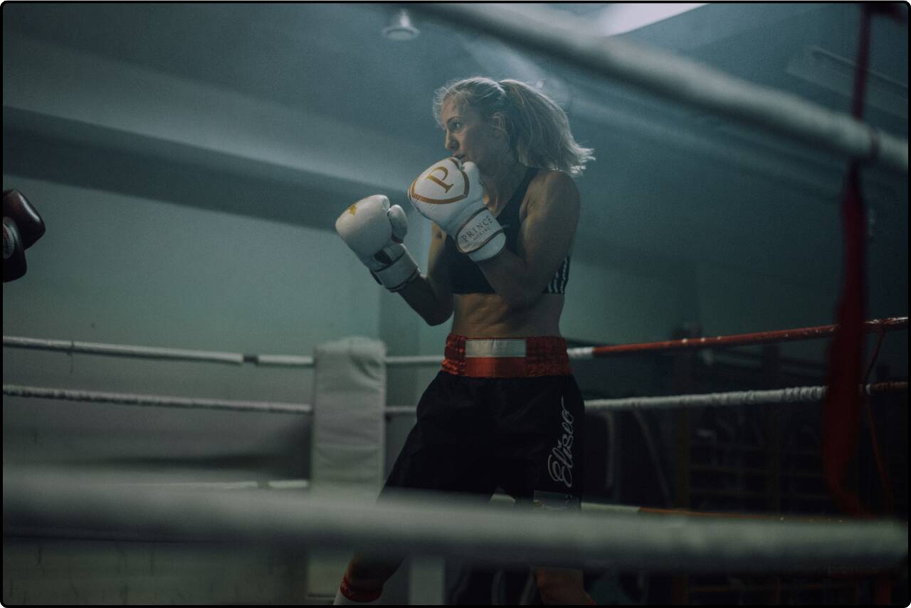 Woman training in a boxing gym, practicing her moves.